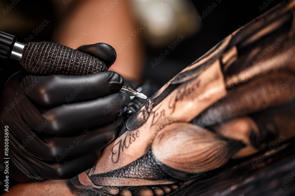 Close-up of intricate tattoo detail work showing fine line artistry