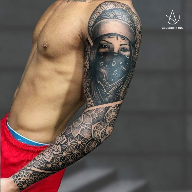 Intricate full sleeve tattoo with geometric patterns and portraiture