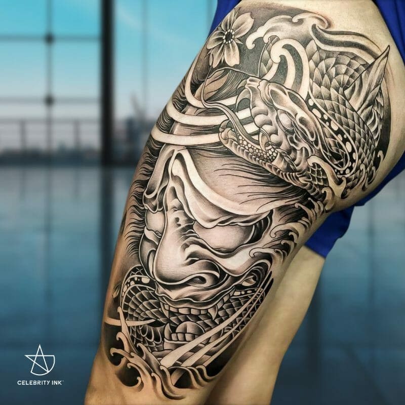 Traditional Japanese style tattoo of a demon mask and snake