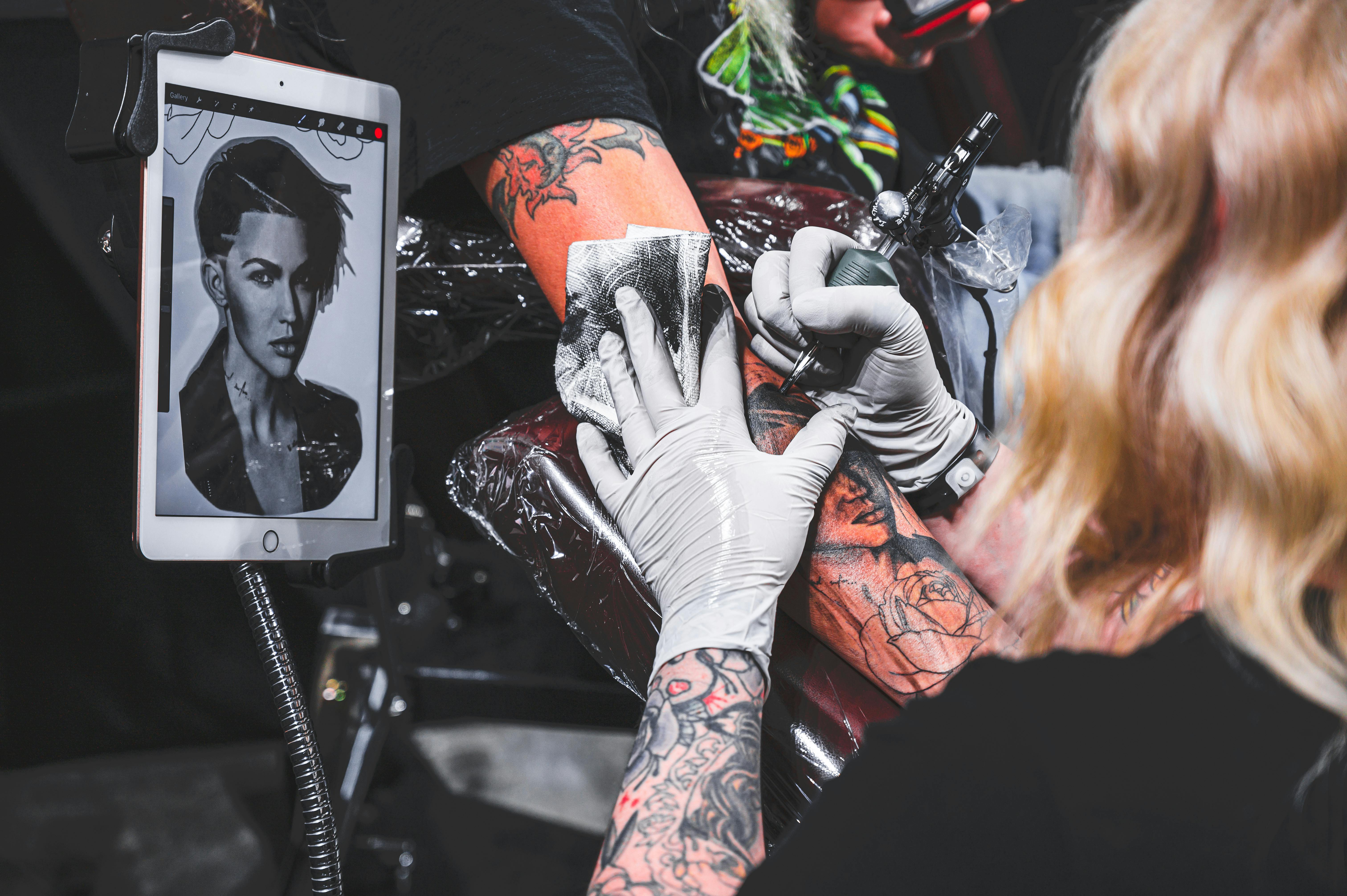 Detailed portrait tattoo being created with precision and skill