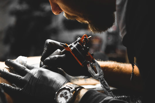 Professional tattoo machine in action during a tattoo session